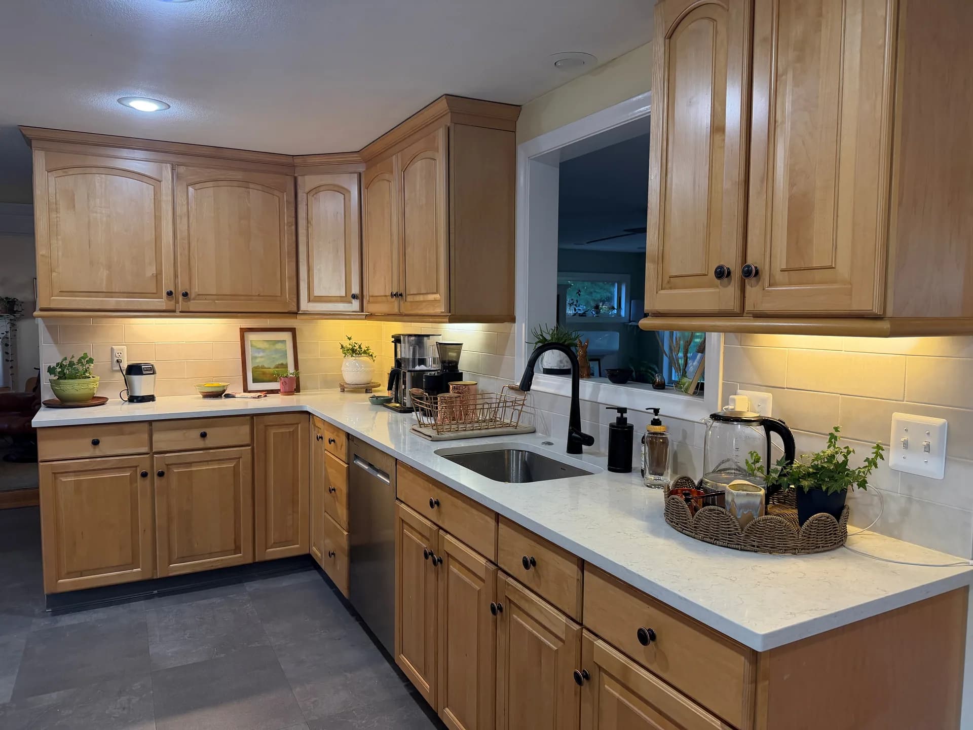 Completed kitchen backsplash wrapping the L-shaped countertop and running behind the sink in West Hartford.